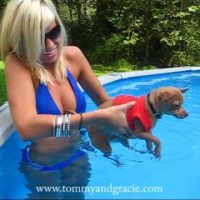 woman holding dog in pool