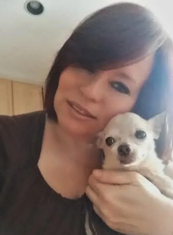 Woman holding Fawn Chihuahua.