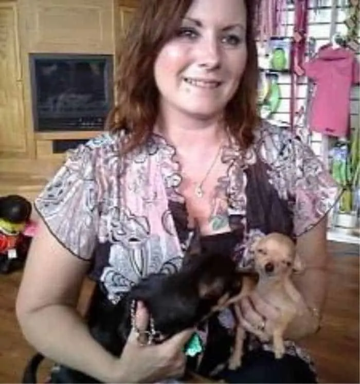 woman holding 2 chihuahuas