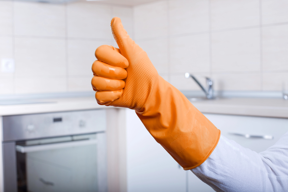 Hand doing thumbs up wearing orange rubber glove.