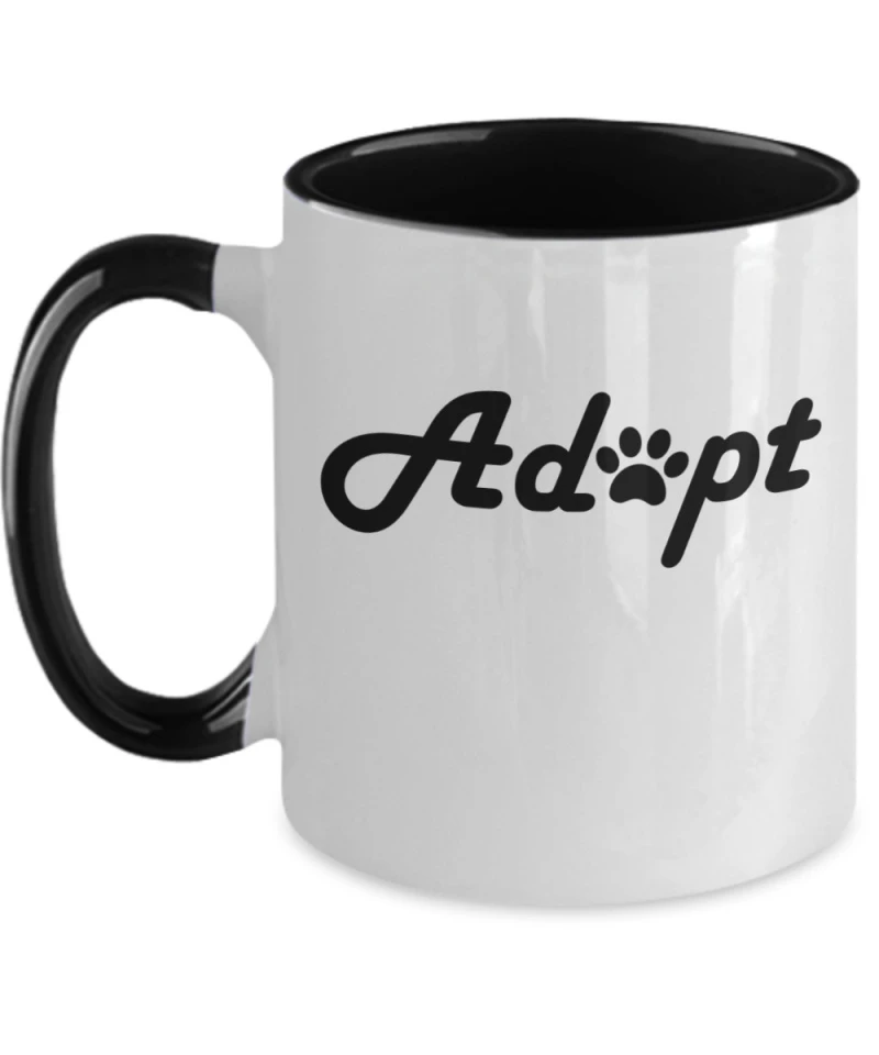 White mug with black handle says Adopt